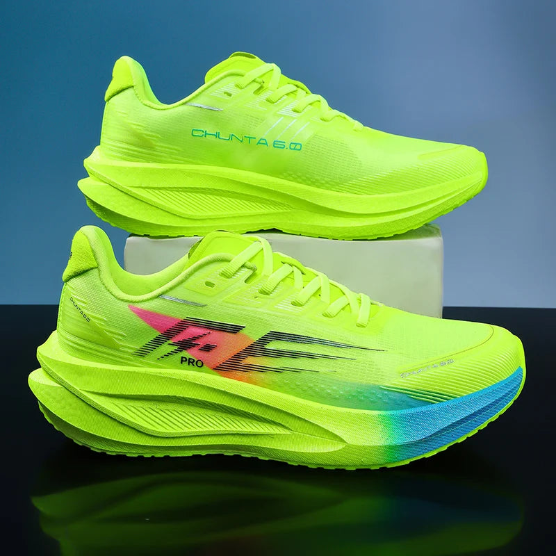 Two neon yellow-green running shoes displayed on a reflective black surface with a blue gradient background. The top shoe is positioned behind the bottom shoe on a small white block.