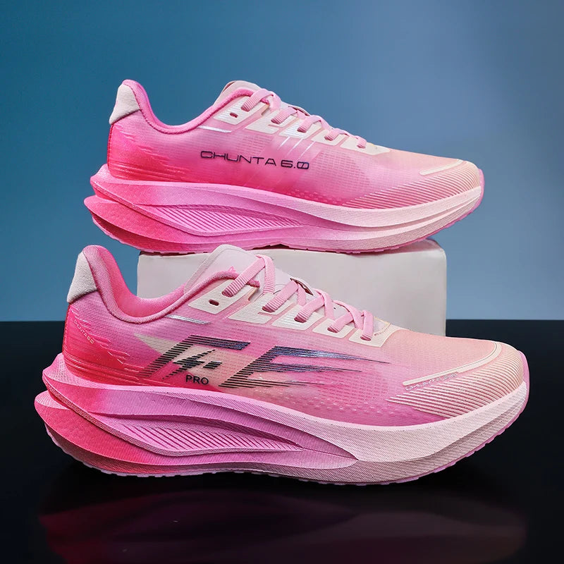 A pair of pink running shoes, with the top shoe resting on a white block above the bottom shoe. The shoes feature a vibrant pink gradient design, thick sculpted midsoles, and branding text 'CHUNTA 6.